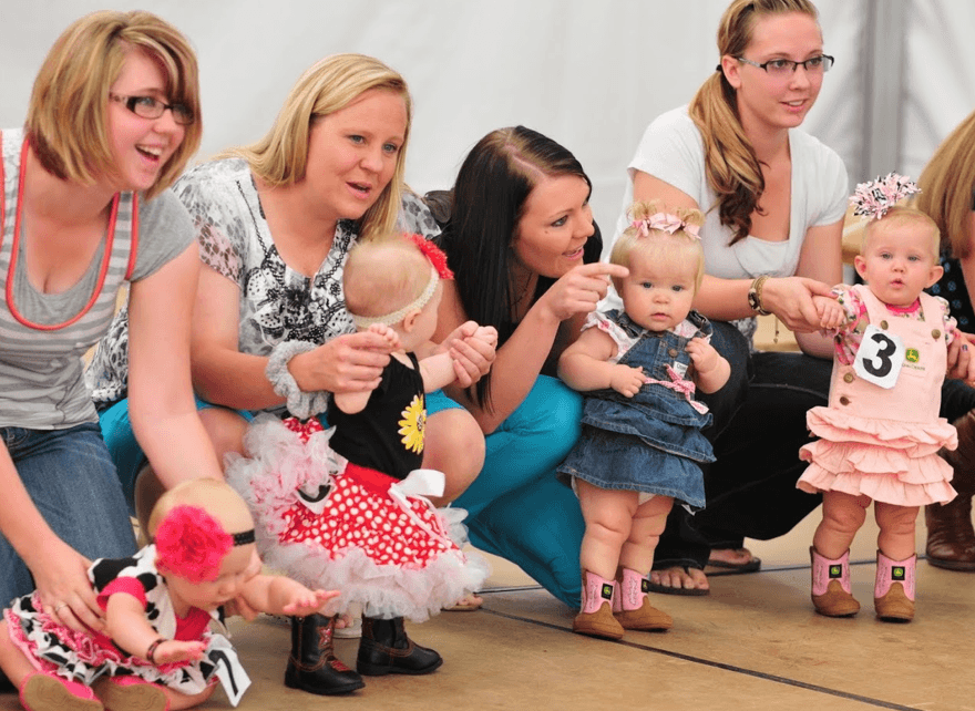 Mothers and babys looking at the crowd