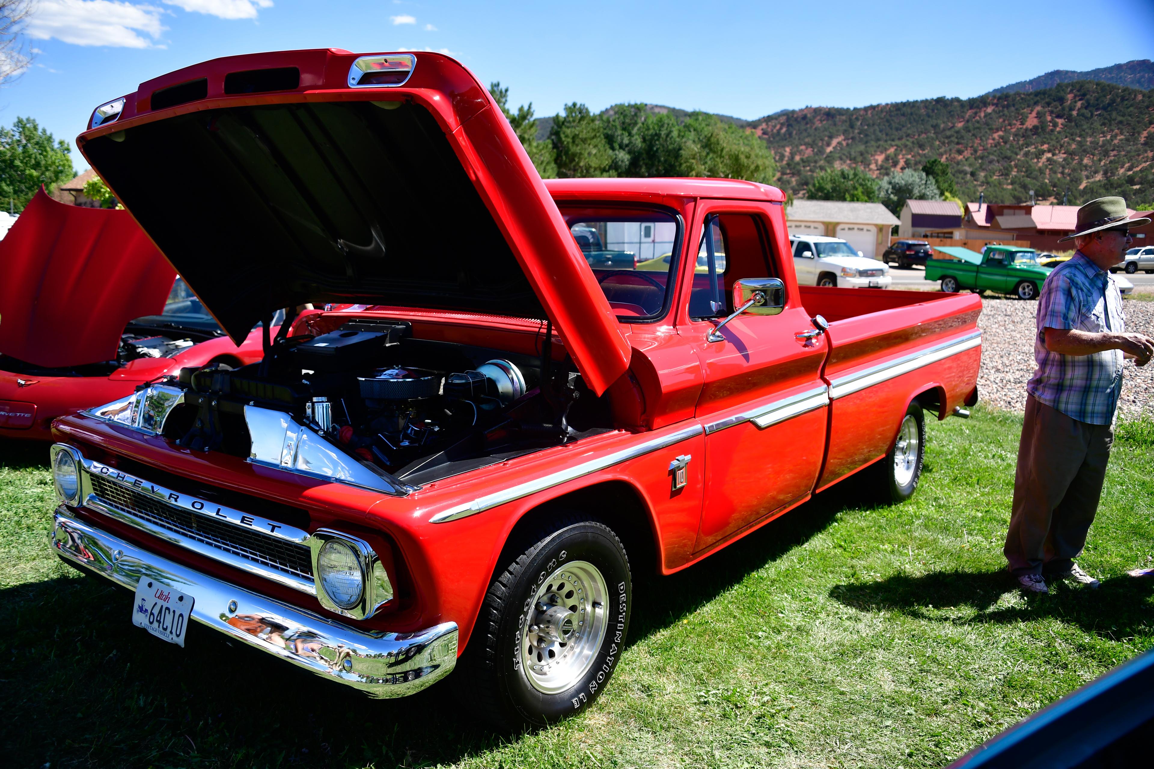 red truck with hood open