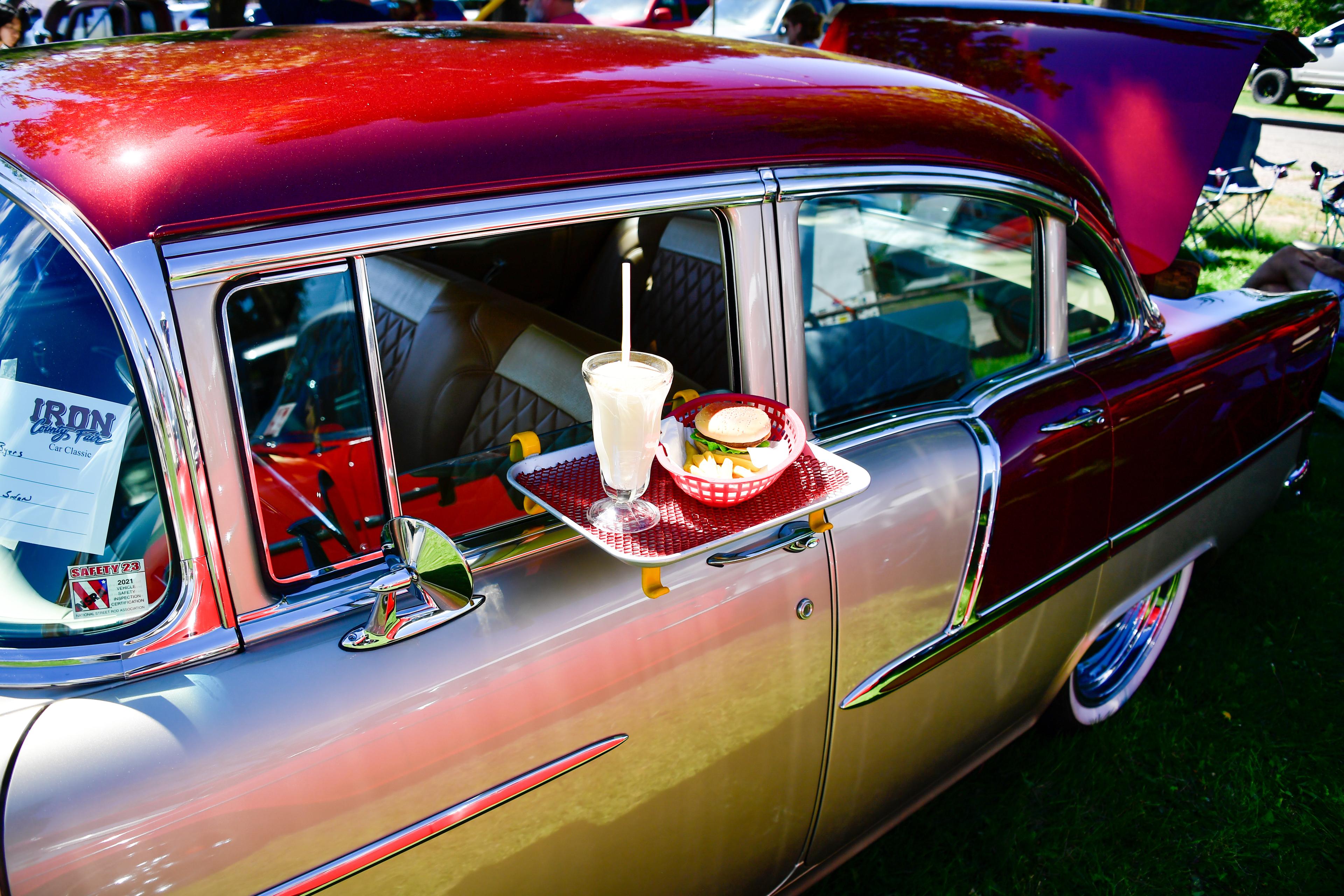 red car with food tray out the window