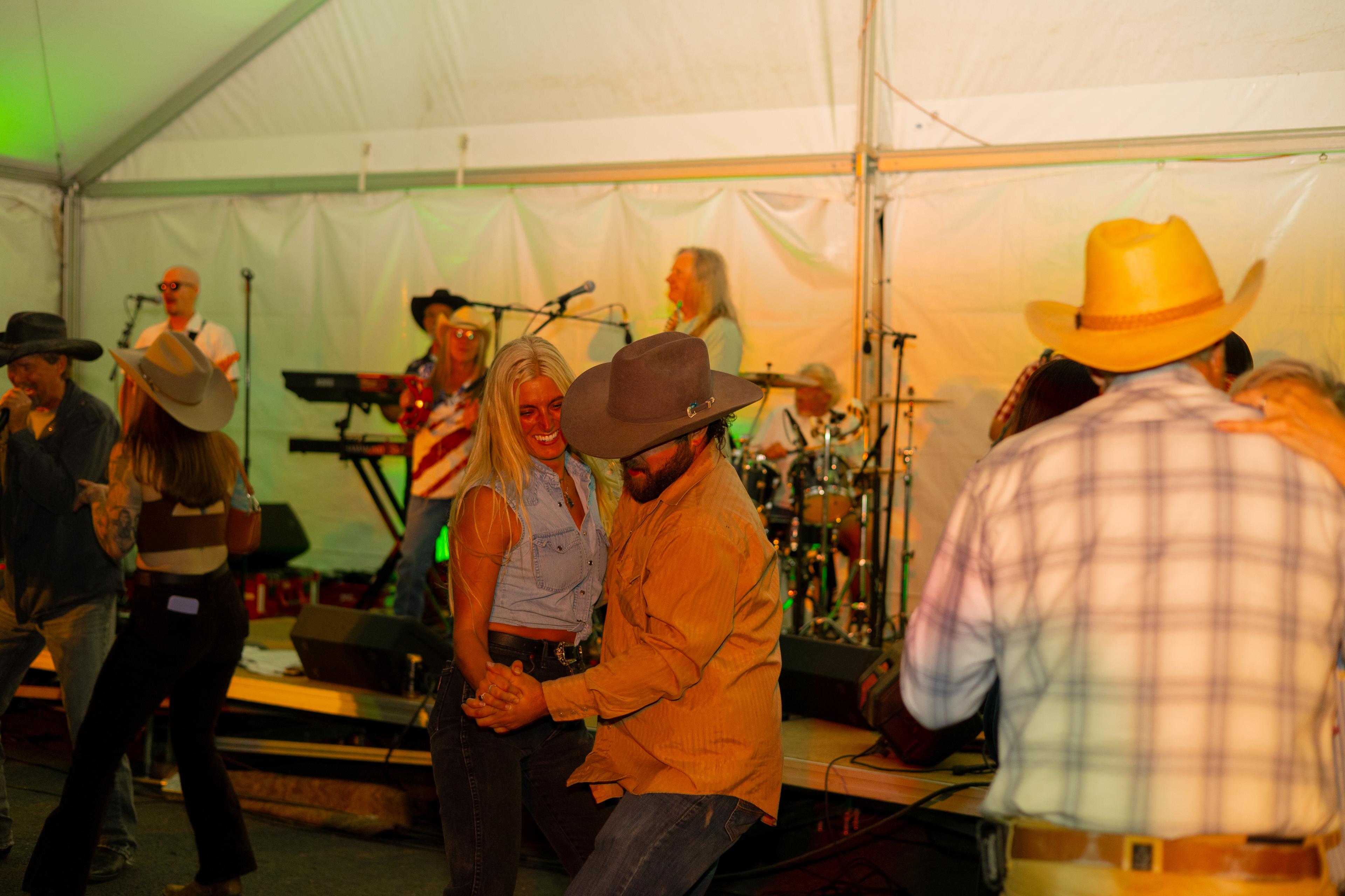 Couple dancing in front of a band