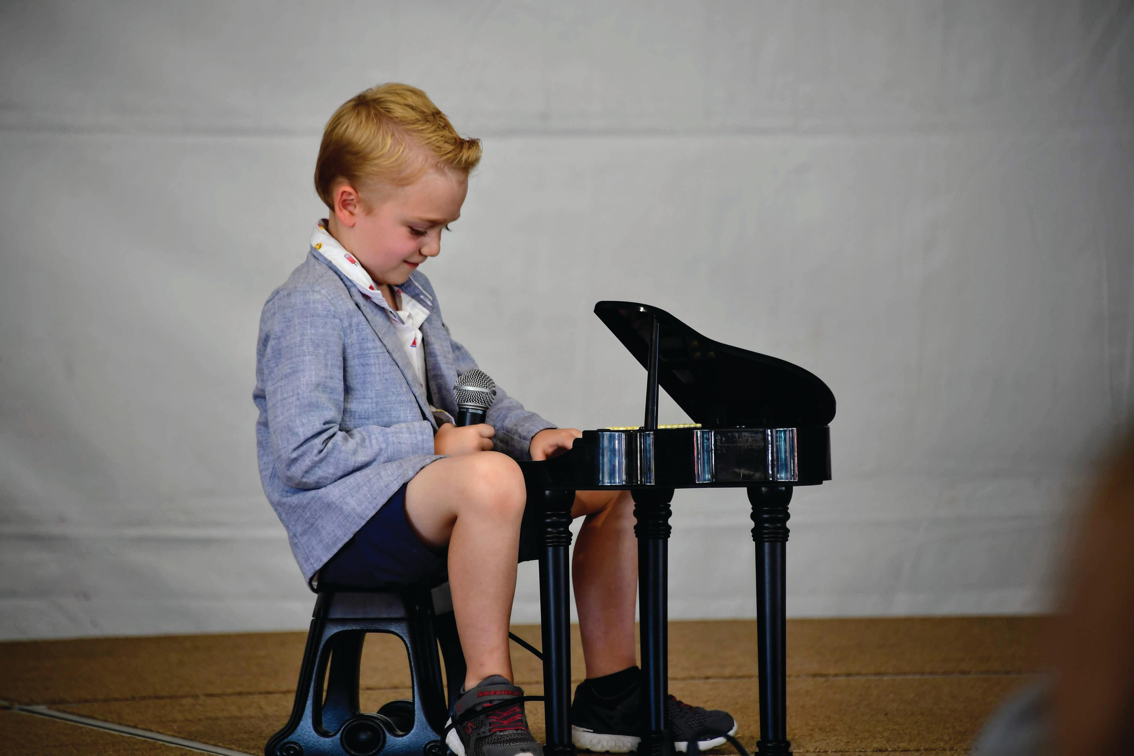 boy playing mini piano
