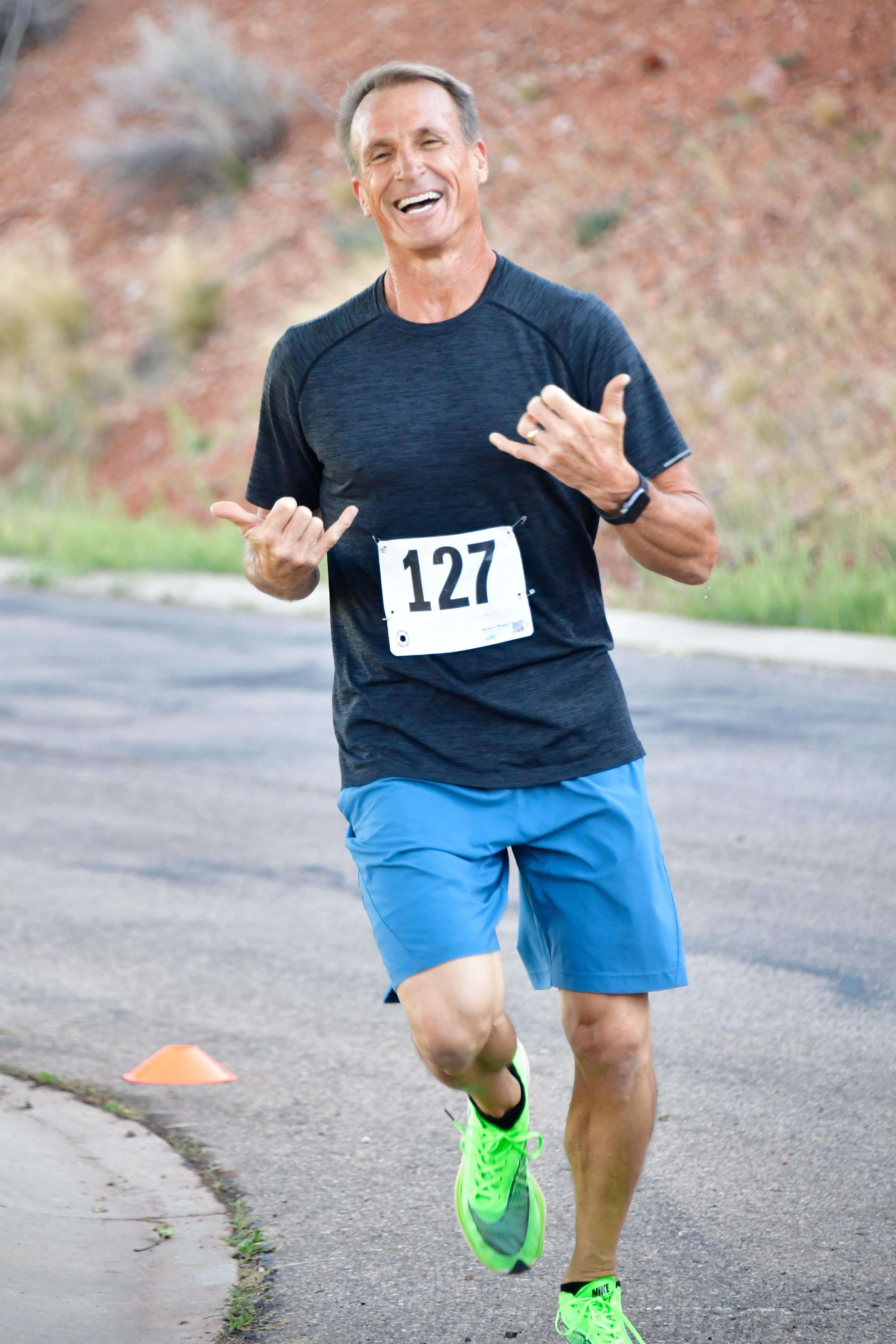 man running and showing hang loose with his hands